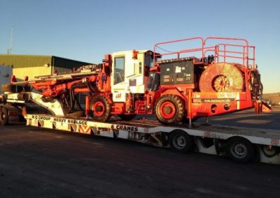 Enclosed cabin model Jumbo being unloaded at site from transport on completion of rebuild